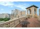 Expansive rooftop terrace featuring architectural details, tables, chairs, and a stunning city view at 75 Ponce De Leon Ne Ave # 1004, Atlanta, GA 30308