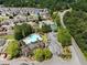 Community aerial view featuring a swimming pool, tennis courts, parking, and lush landscaping at 114 Batten Board Way, Woodstock, GA 30189
