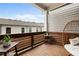 Cozy covered balcony with wood paneling and comfortable seating, ideal for relaxation and enjoying the view at 114 Batten Board Way, Woodstock, GA 30189
