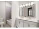 Elegant bathroom featuring a double vanity with quartz countertops and modern fixtures, plus a tub at 114 Batten Board Way, Woodstock, GA 30189