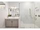 Modern bathroom features walk-in shower, marble tile, and sleek fixtures with a large mirror at 114 Batten Board Way, Woodstock, GA 30189