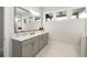 Bright bathroom boasts double vanity with large mirror, ample counter space, and recessed lighting at 114 Batten Board Way, Woodstock, GA 30189