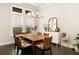 Dining room featuring a wooden table with seating for six, modern light fixture, and large windows at 114 Batten Board Way, Woodstock, GA 30189