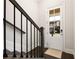Entryway featuring dark wood floors, white walls, and a staircase with wrought iron railings at 114 Batten Board Way, Woodstock, GA 30189