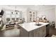 Bright kitchen with a large island, stainless steel appliances, and an open view to the living and dining areas at 114 Batten Board Way, Woodstock, GA 30189