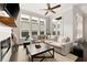Spacious living room featuring a large sectional sofa, multiple windows, and a fireplace with a TV at 114 Batten Board Way, Woodstock, GA 30189