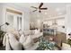 Comfortable living room featuring a large sectional sofa, wooden coffee table, and an open view to the kitchen at 114 Batten Board Way, Woodstock, GA 30189