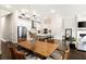 Open-concept space with a dining table and chairs in view of the living room and kitchen at 114 Batten Board Way, Woodstock, GA 30189