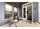 Inviting patio with seating and direct access to the home's interior through elegant glass doors at 114 Batten Board Way, Woodstock, GA 30189