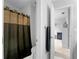 Bathroom featuring a shower with curtain and a glimpse of bedroom beyond at 1613 Brolington Ct, Conyers, GA 30013