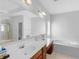 Bright bathroom with double sinks, large mirror, and a soaking tub next to a shower at 1613 Brolington Ct, Conyers, GA 30013