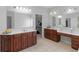 Bathroom featuring and sinks, expansive counter space, and dark wood cabinets at 1613 Brolington Ct, Conyers, GA 30013