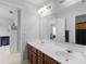 Bathroom with a double sink vanity, large mirror, and modern fixtures at 1613 Brolington Ct, Conyers, GA 30013