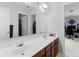 Bathroom featuring a double sink vanity, large mirror, and modern fixtures at 1613 Brolington Ct, Conyers, GA 30013