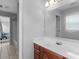 Bright bathroom featuring a single vanity and adjacent shower and bathtub at 1613 Brolington Ct, Conyers, GA 30013
