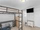 Bedroom showcasing bunk bed with desk, TV, and ample storage and natural light at 1613 Brolington Ct, Conyers, GA 30013
