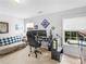 Bedroom with windows, a gaming computer setup, and a comfortable sofa at 1613 Brolington Ct, Conyers, GA 30013