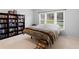 Bedroom with carpet, window, and bookshelf filled with an array of books at 1613 Brolington Ct, Conyers, GA 30013