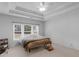 Cozy bedroom with tray ceiling, plush carpet and a large sunlit window at 1613 Brolington Ct, Conyers, GA 30013