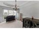 Formal dining room with a chandelier, large windows, and neutral-toned decor and wainscoting at 1613 Brolington Ct, Conyers, GA 30013