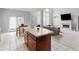 Spacious open concept with kitchen island, a view of the living room with large windows and a fireplace at 1613 Brolington Ct, Conyers, GA 30013