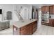 Open kitchen featuring a center island, stainless steel appliances, and light-colored countertops and flooring at 1613 Brolington Ct, Conyers, GA 30013
