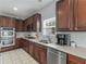 Well-lit kitchen featuring stainless steel appliances, wood cabinets, and a window above the sink at 1613 Brolington Ct, Conyers, GA 30013