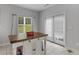Bright kitchen nook featuring tile floors, an island, and natural light at 1613 Brolington Ct, Conyers, GA 30013