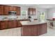 Open concept kitchen with wood cabinets, stainless steel appliances, and a center island with seating at 1613 Brolington Ct, Conyers, GA 30013
