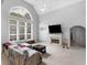 Bright living room with cathedral ceiling, large arched window and fireplace at 1613 Brolington Ct, Conyers, GA 30013