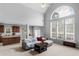 Open-concept living room with cathedral ceiling, arched window, and seamless flow to kitchen at 1613 Brolington Ct, Conyers, GA 30013