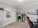 Bright room featuring french doors, neutral walls, plush carpet and a variety of decor at 1613 Brolington Ct, Conyers, GA 30013