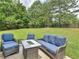 Outdoor patio with blue cushioned seating and natural landscape views at 1613 Brolington Ct, Conyers, GA 30013
