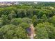 An aerial view shows the property nestled among lush trees in a serene setting at 311 Glendale Ave, Decatur, GA 30030