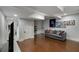 Finished basement featuring hardwood floors, a sofa, a tv, and a decorated wall at 311 Glendale Ave, Decatur, GA 30030