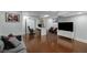 Finished basement featuring hardwood floors, a tv, a sofa, and a desk with rolling chairs at 311 Glendale Ave, Decatur, GA 30030