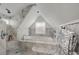 Luxurious bathroom featuring marble walls, a soaking tub, a rain shower, and a large window for natural light at 311 Glendale Ave, Decatur, GA 30030