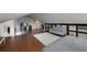 Open bedroom with hardwood floors, a large rug, a doorway, and a couch at 311 Glendale Ave, Decatur, GA 30030