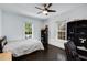 Bright bedroom with hardwood floors, a ceiling fan, two windows, and a comfortable bed at 311 Glendale Ave, Decatur, GA 30030