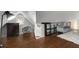 Open bedroom with hardwood floors, a large rug, a window, and a chair at 311 Glendale Ave, Decatur, GA 30030