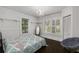 Bright bedroom featuring a decorative chandelier, two windows, and hardwood floors at 311 Glendale Ave, Decatur, GA 30030