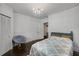 Bright bedroom featuring a decorative chandelier, a doorway, and hardwood floors at 311 Glendale Ave, Decatur, GA 30030