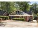 Rear exterior shot of the beautiful brick home showing the driveway and shrubbery at 311 Glendale Ave, Decatur, GA 30030