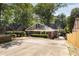 Back exterior view of home showcasing landscaping, driveway and brick facade at 311 Glendale Ave, Decatur, GA 30030