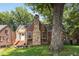 Charming brick home with a striking stone chimney and mature landscaping at 311 Glendale Ave, Decatur, GA 30030