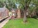 Brick home featuring a stone chimney and walkway, complemented by a well-maintained lawn at 311 Glendale Ave, Decatur, GA 30030