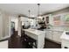 Bright kitchen features white cabinets, marble counters, stainless appliances and eat-in island at 311 Glendale Ave, Decatur, GA 30030