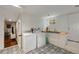 Functional laundry room with modern appliances, a large sink, patterned floor tiles, and ample storage space at 311 Glendale Ave, Decatur, GA 30030