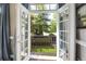 Balcony view through open french doors, showcasing the lush greenery at 3663 Brookhaven Manor Crossing Ne, Atlanta, GA 30319