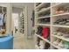 Organized walk-in closet with shelving for shoes, bags, and a full length mirror at 3663 Brookhaven Manor Crossing Ne, Atlanta, GA 30319